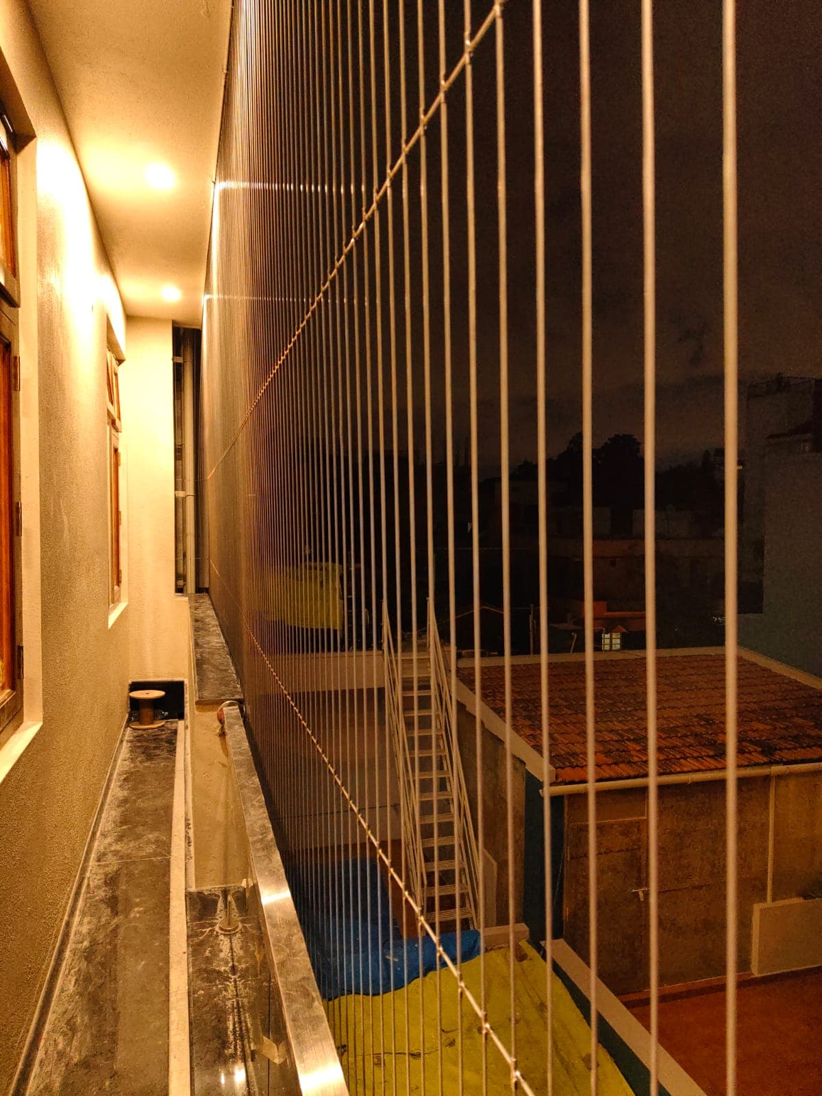 Modern balcony styling showing invisible safety grills replacing traditional bulky iron bars in Vijayawada - AJ Safe Net Solutions