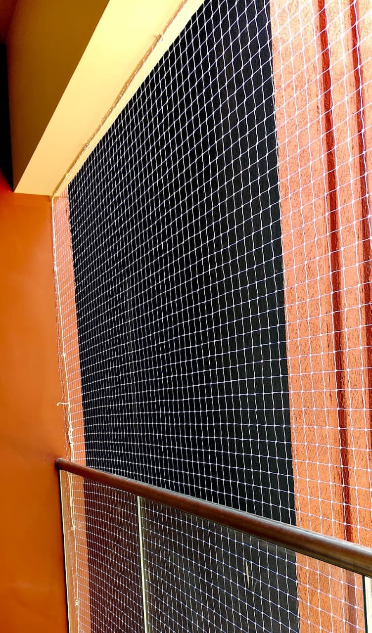 Professional installation of SS 316 steel wire invisible grills in modern apartment balcony - AJ Safe Net Solutions